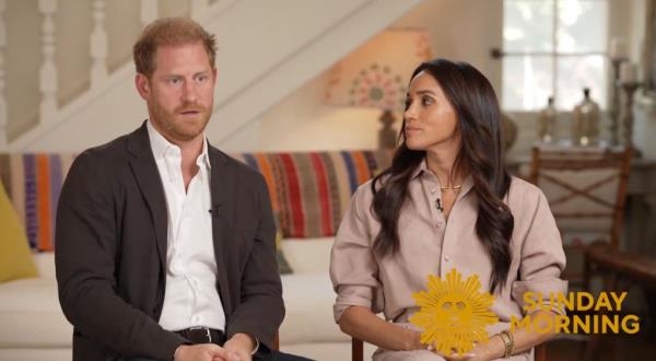 Prince Harry and Meghan Markle on a couch. 