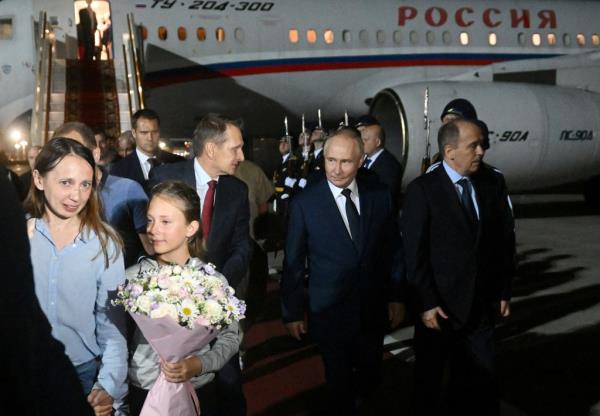 Russia's President Vladimir Putin, Director of the Federal Security Service (FSB) Alexander Bortnikov and Foreign Intelligence Service (SVR) Director Sergey Naryshkin welcome Russian nationals, who were released in a priso<em></em>ner exchange between Russia with Western countries