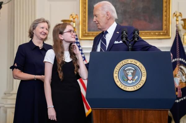 President Joe Biden, right, looking over to Miriam Butorin, center, as Elizabeth Whelan, left, looks on after he delivered remarks on a priso<em></em>ner swap with Russia from the State Dining Room of the White House, Thursday, Aug. 1, 2024, in Washington. 