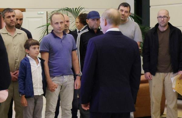 Russian President Vladimir Putin, front, greets released Russian priso<em></em>ners and relatives at the government terminal of the Vnukovo airport in Moscow, Russia, Aug. 1, 2024.