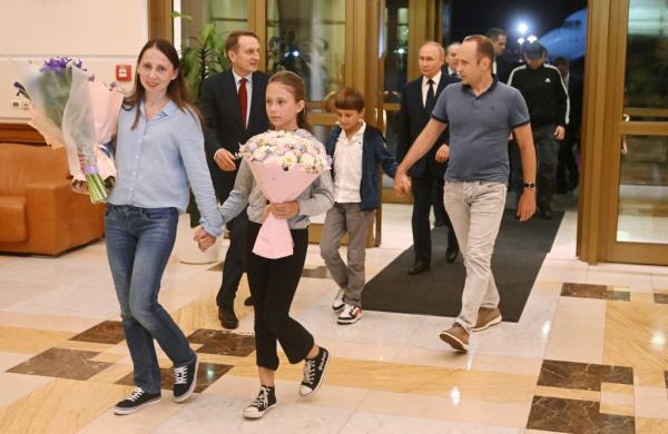 Vladimir Putin walks behind Russian natio<em></em>nals Artyom Dultsev, Anna Dultseva and their children following a priso<em></em>ner exchange during a welcoming ceremony at Vnukovo Internatio<em></em>nal Airport in Moscow, Russia August 1, 2024.