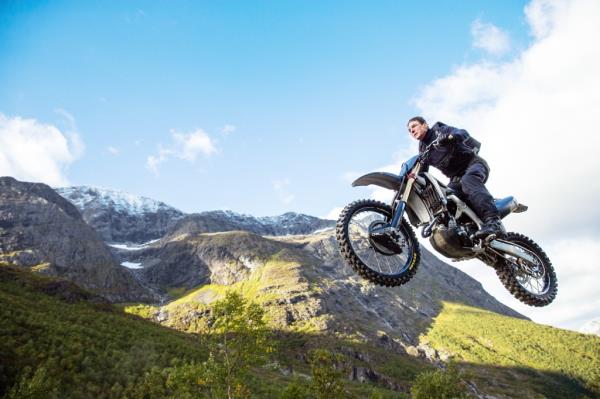 Tom Cruise riding his motorcycle in the air. 