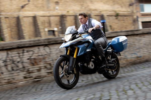 Tom Cruise riding a motorcycle. 