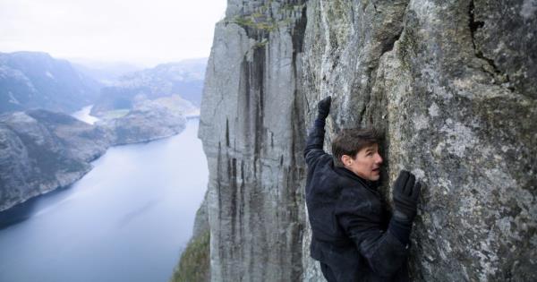 Tom Cruise on a wall high in the air. 