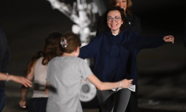 Kurmasheva runs to her daughters Miriam Butorin and Bibi Butorinas as she arrives at Joint ba<em></em>se Andrews in Maryland on August 1, 2024. 