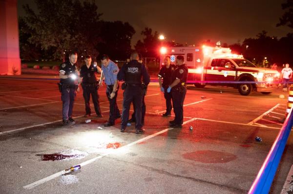 Police and EMS are seen at parking field 71 on Randall's Island in New York wher<em></em>e three people were shot, one fatally, on Monday, July 29, 2024. 