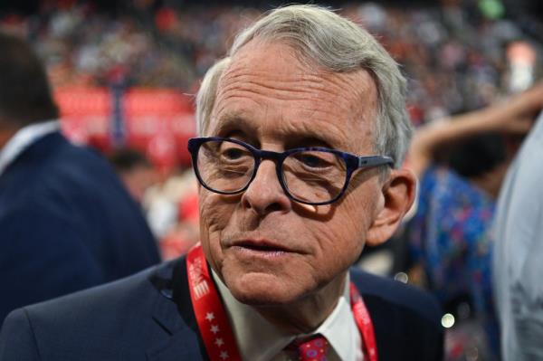 Ohio Governor Mike DeWine in a suit and glasses, attending the Republican Natio<em></em>nal Co<em></em>nvention in Milwaukee, Wisconsin, taking a stand against a Democrat-led proposal