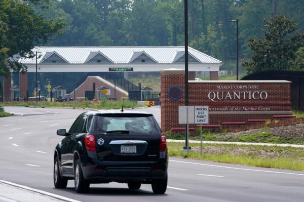 A car drives past the entrance sign for Marine Corps ba<em></em>se Quantico.