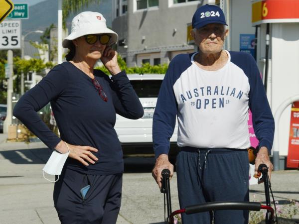 George Lazenby walking with his ex-wife.