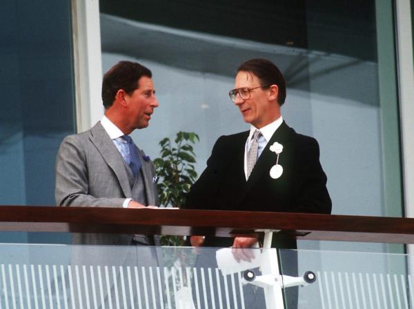 Sir Robert Fellowes in co<em></em>nversation with Charles, the then-Prince of Wales, at Epsom Derby in 1993