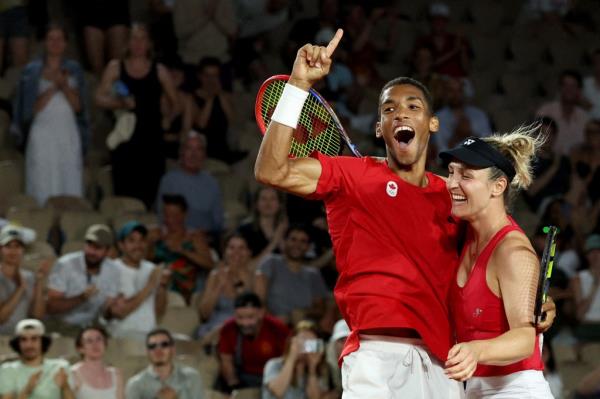 Gabriela Dabrowski of Canada and Felix Auger-Aliassime of Canada celebrate after winning their match against Coco Gauff of United States and Taylor Fritz