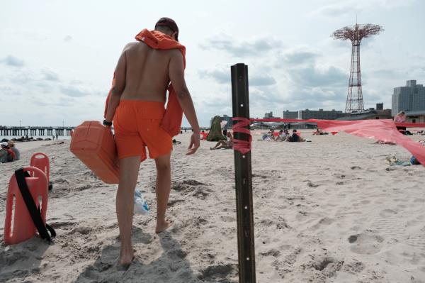 A lifeguard works at the beach at Co<em></em>ney Island.