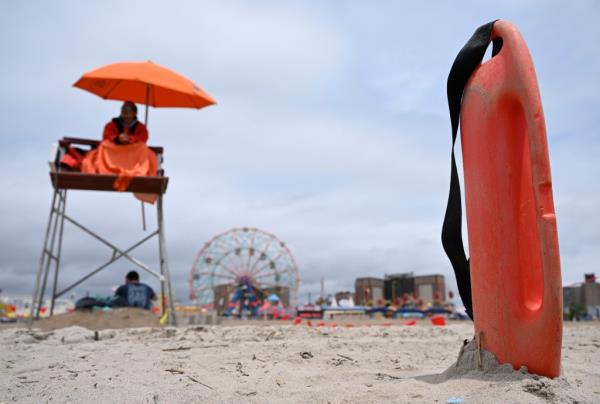 A lifeguard works at the beach at Co<em></em>ney Island.