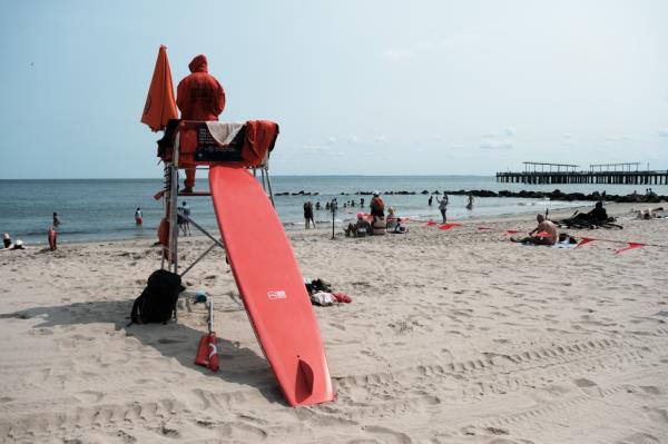 A lifeguard works at the beach at Co<em></em>ney Island.