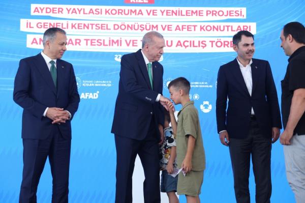 boy kisses Erdogan's hand