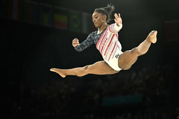 Simone Biles soaring in the air.