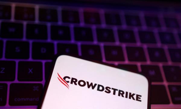 Illustration of CrowdStrike logo displayed on a phone resting on a keyboard, dated July 29, 2024.