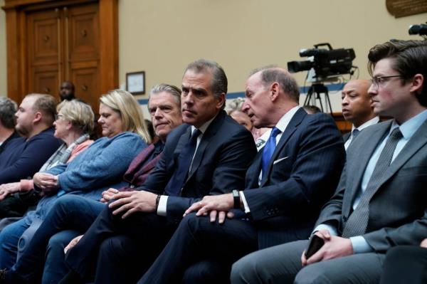 Hunter Biden sitting with his lawyers.