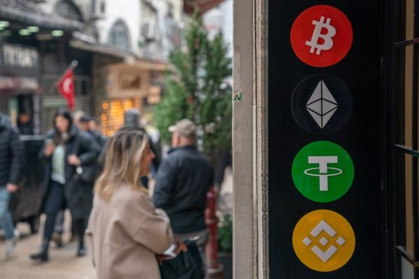 The logos for Bitcoin, Etherium, Tether and Binance, top to bottom, outside a cryptocurrency exchange bureau in Istanbul, Turkey, on Friday, March 1, 2024.