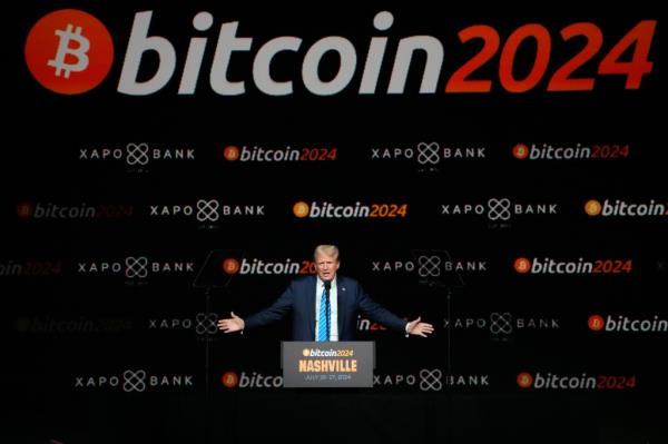 Trump speaking on stage at Bitcoin Conference.