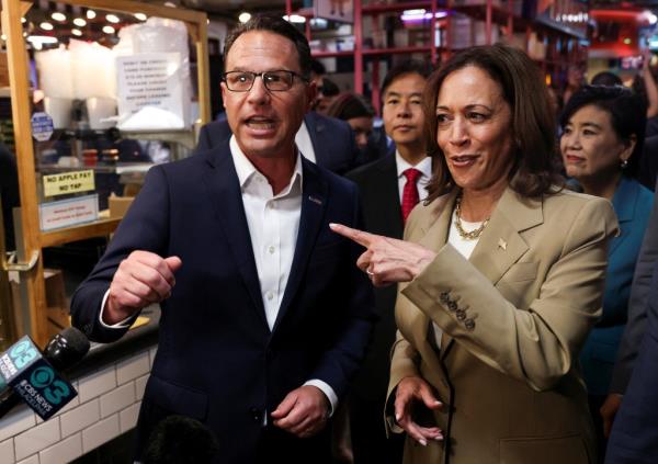 U.S. Vice President Kamala Harris and Pennsylvania Governor Josh Shapiro speak to members of the media as they visit the Reading Terminal Market in Philadelphia, Pennsylvania, U.S., July 13, 2024.