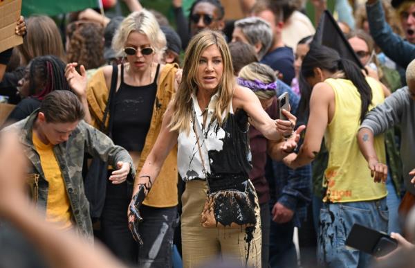 Jennifer Aniston walking in a crowd. 