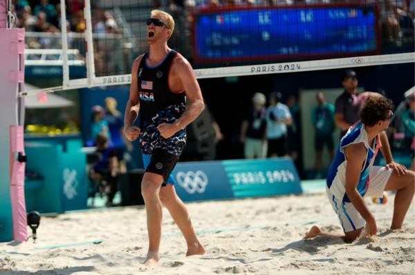 United States' Chase Budinger celebrates a block against France in a beach volleyball match at the 2024 Summer Olympics, Monday, July 29, 2024, in Paris, France.